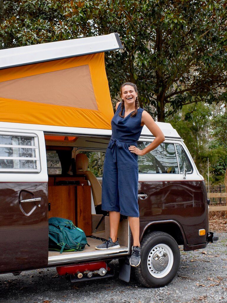 about the blog nicola standing in a campervan with a yellow canvas top