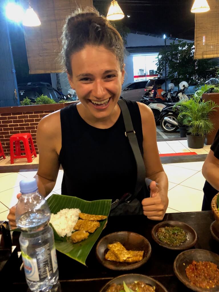 Nicola trying spicy Sambal in Indonesia and giving a thumbs-up sign 