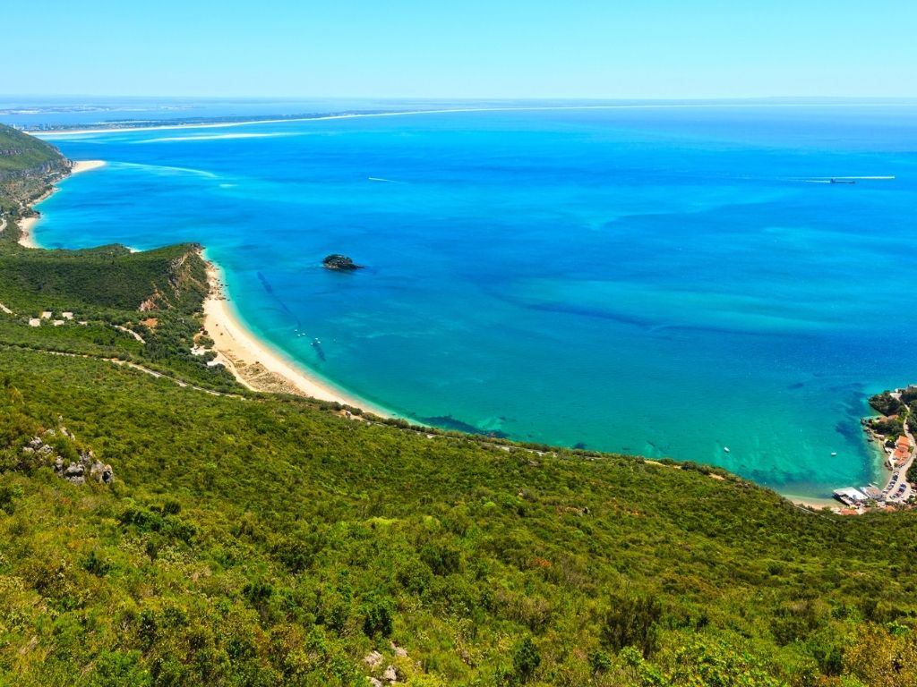 Green forest and clear blue ocean at Arrabida Nature Park