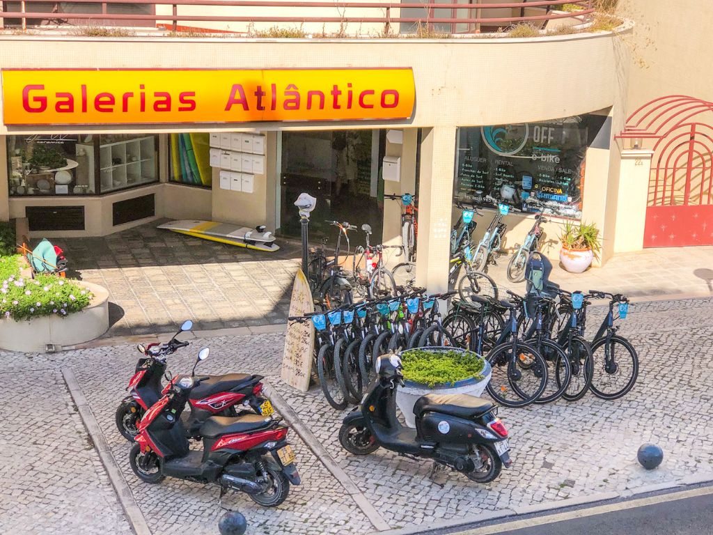 The outside of an ebike rental shop in Ericeira with racks of bikes available for rent
