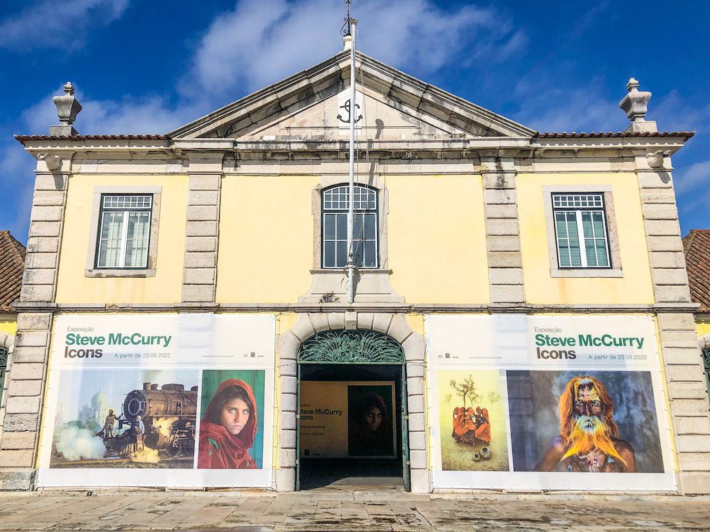 An art gallery in Lisbon with exhibition posters outside and yellow walls