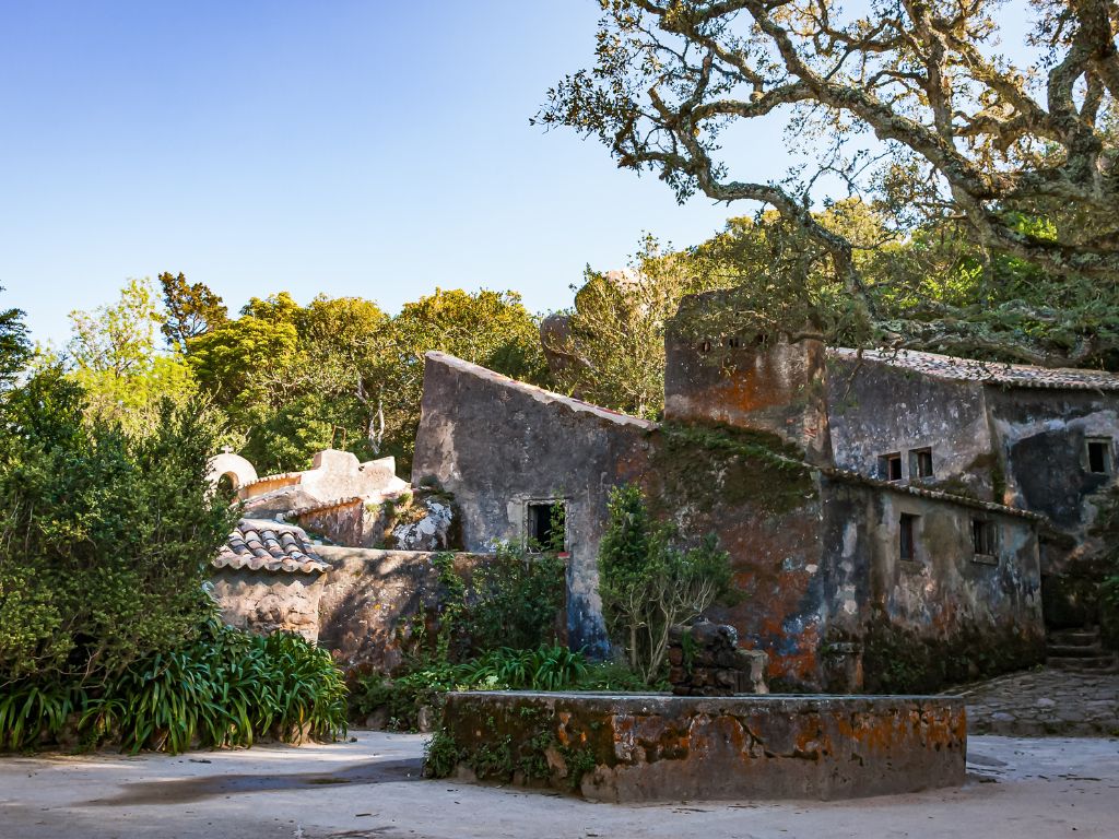 Convento dos Capuchos in Sintra, a stone convent covered in moss and surrounded by trees