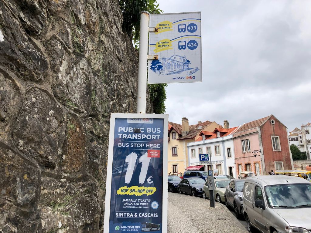 A bus sign in Sintra that reads 11 Euro Hop on Hop Off 24 hour pass