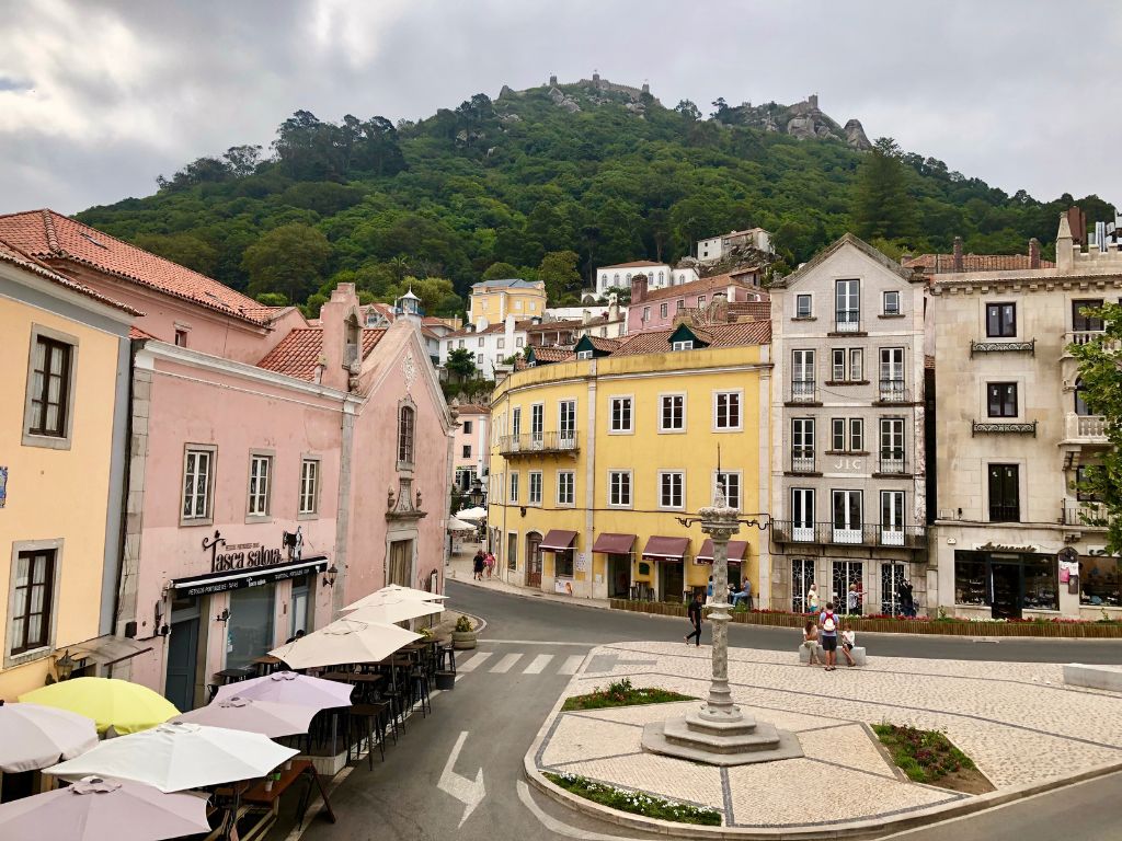 A plaza in Sintra old town surrounded by pink and yellow buildings