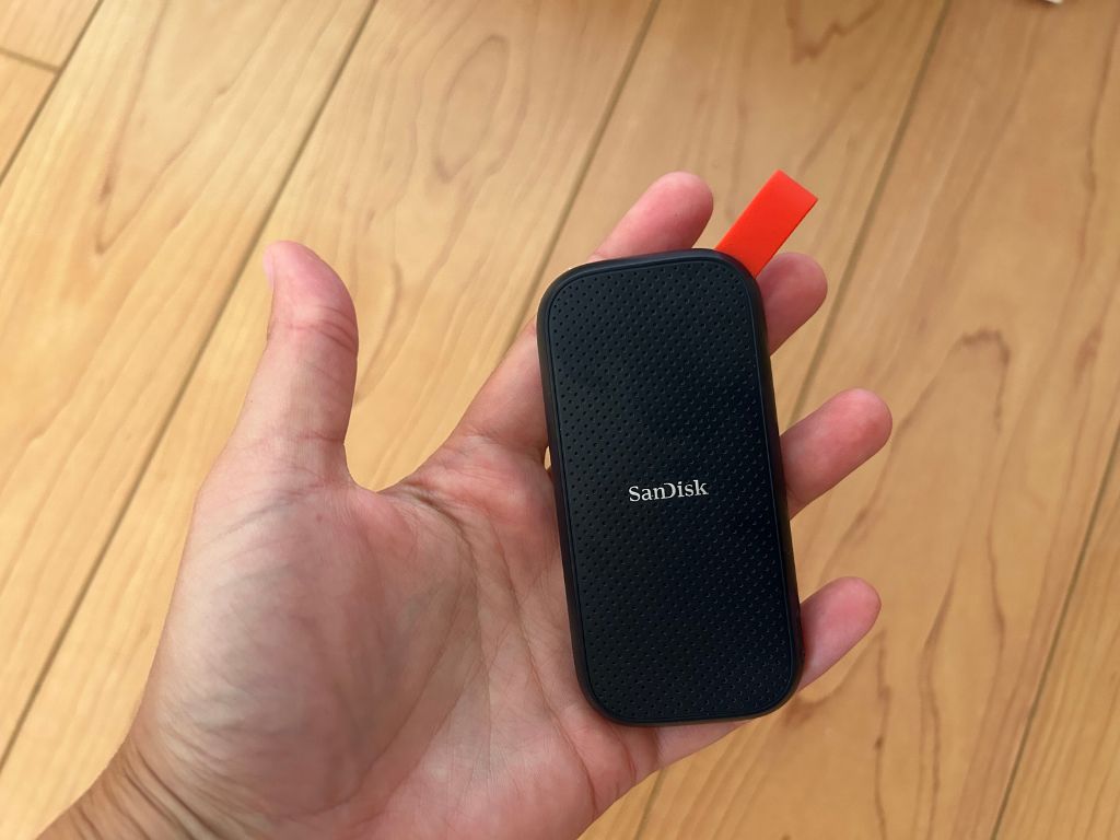 A small portable external hard drive that can fit in the palm of your hand